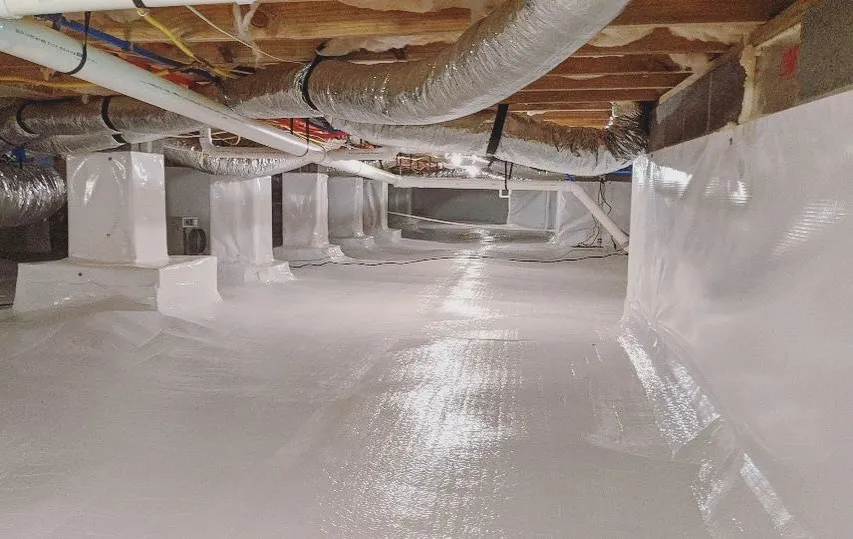 Finished crawl space encapsulation with a bright white sealed liner and wrapped support piers
